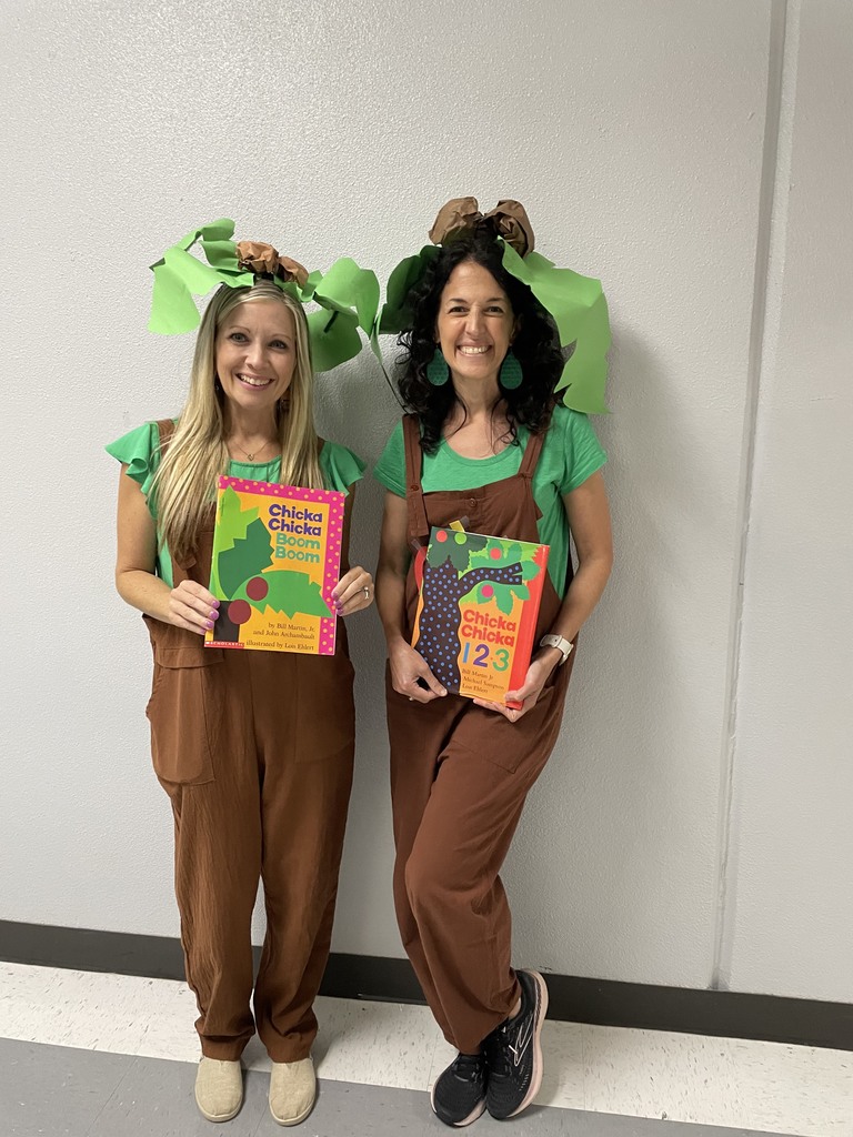 2 teachers dressed up as characters from the books they are holding