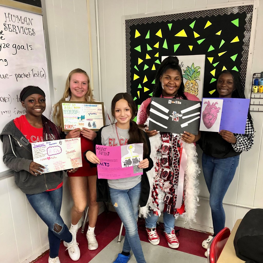 students with informational posters