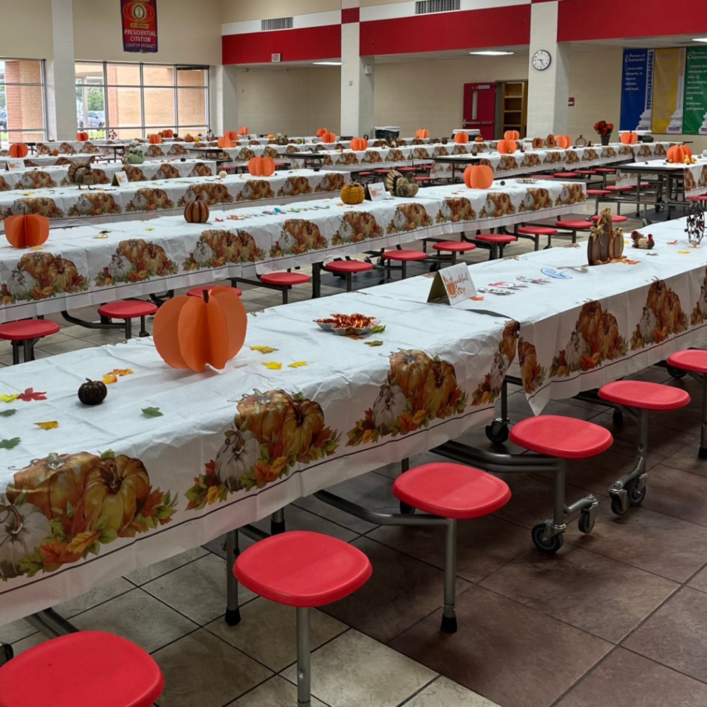 cafeteria tables covered and decorated with fall items