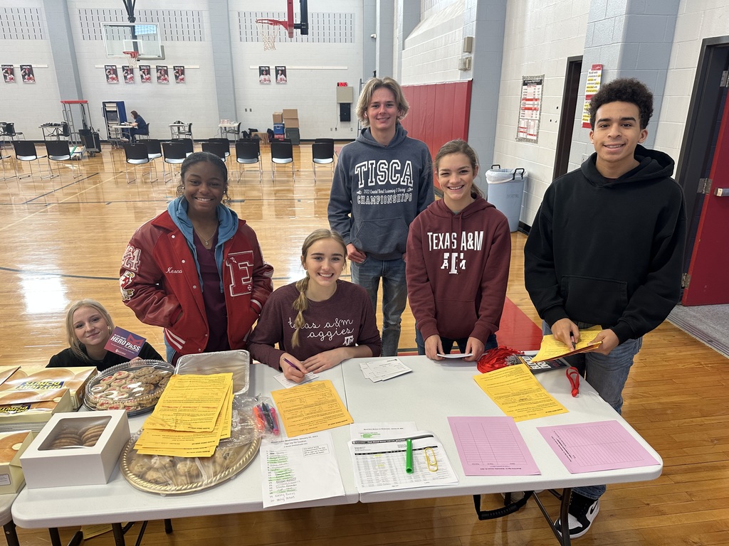 NHS students posing for picture at the registration table