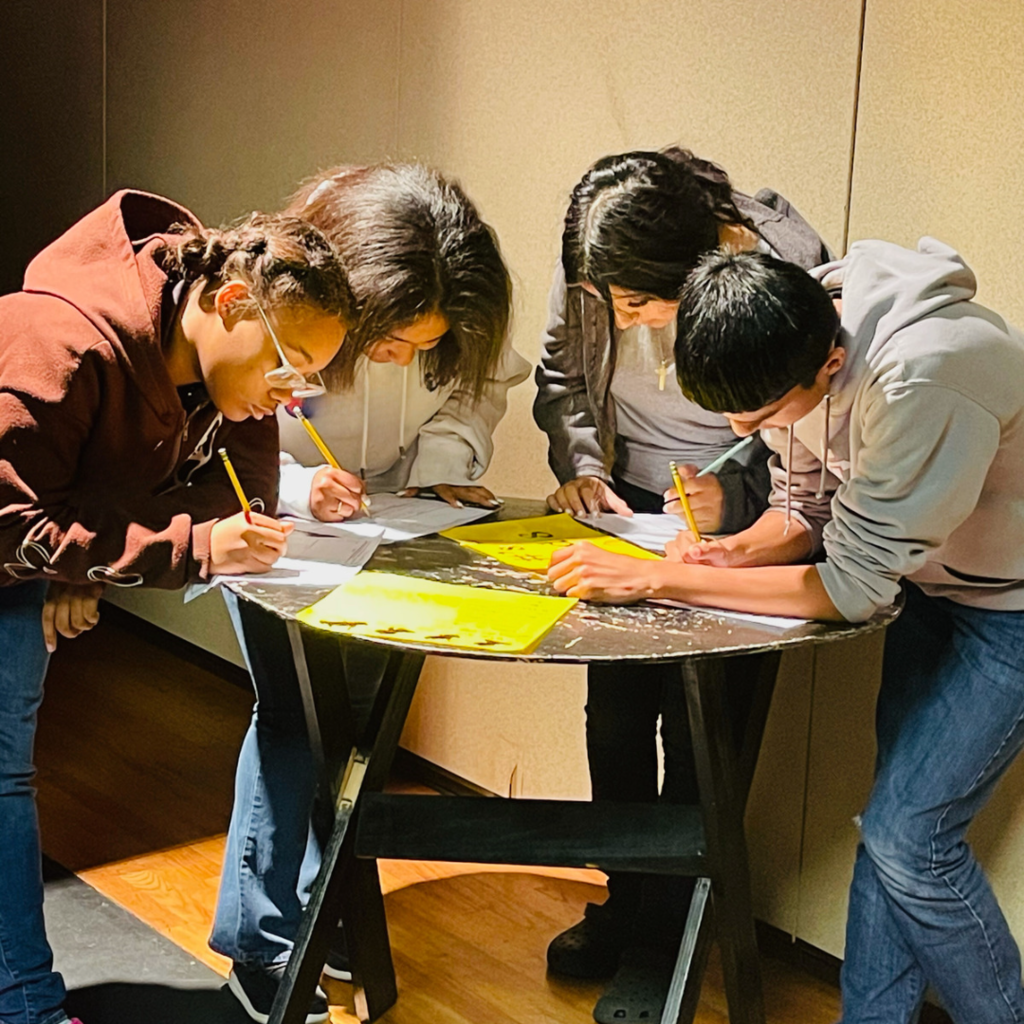 4 students working at a table